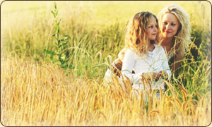 Woman and child sitting in field